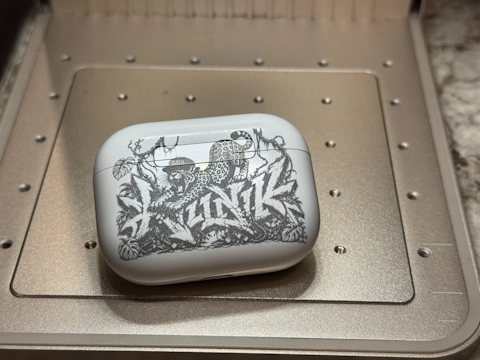 Abstract artwork engraved onto an AirPods case